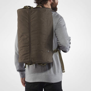 Fjallraven Splitpack Green 35L showing overall size on a person. Length of bag is from the shoulders to a bit before the  hip bone. 