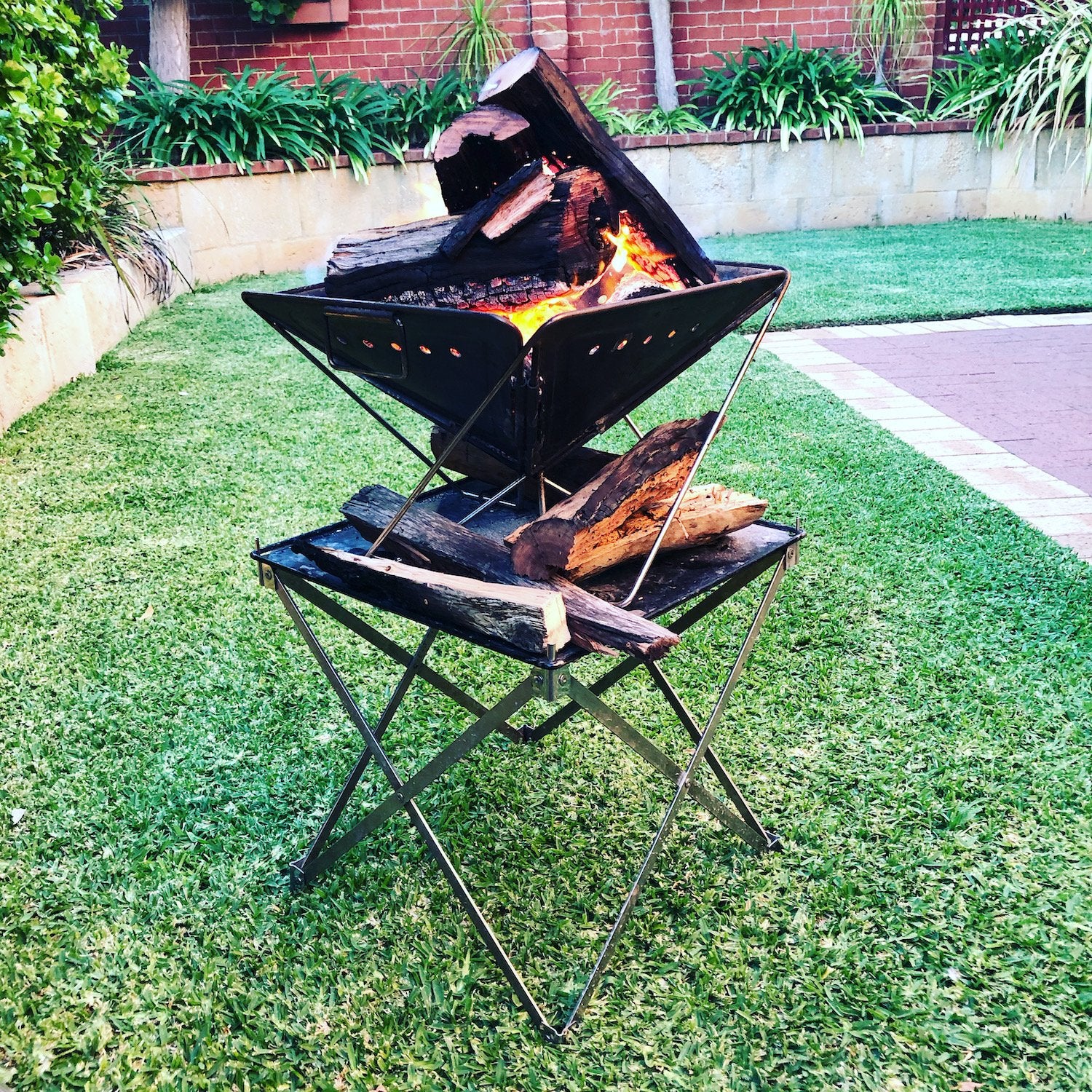 Red Roads Riser, scissor arm collapsible firepit. Comes with the stainless steel mesh  and nylon bag. Also doubles as a stand for the Red Roads Blaze n BBQ Firepit, to increase height. 